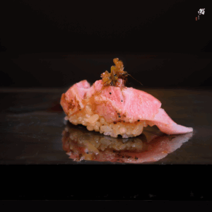 ChatGPT said: Best Omakase Singapore : A close-up of uni sushi topped with salt and lime, capturing its creamy texture