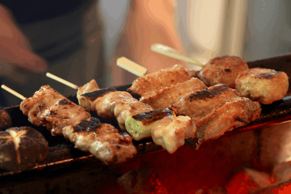 Best Izakaya In SG : Skewers sizzling over charcoal grill with smoky aroma