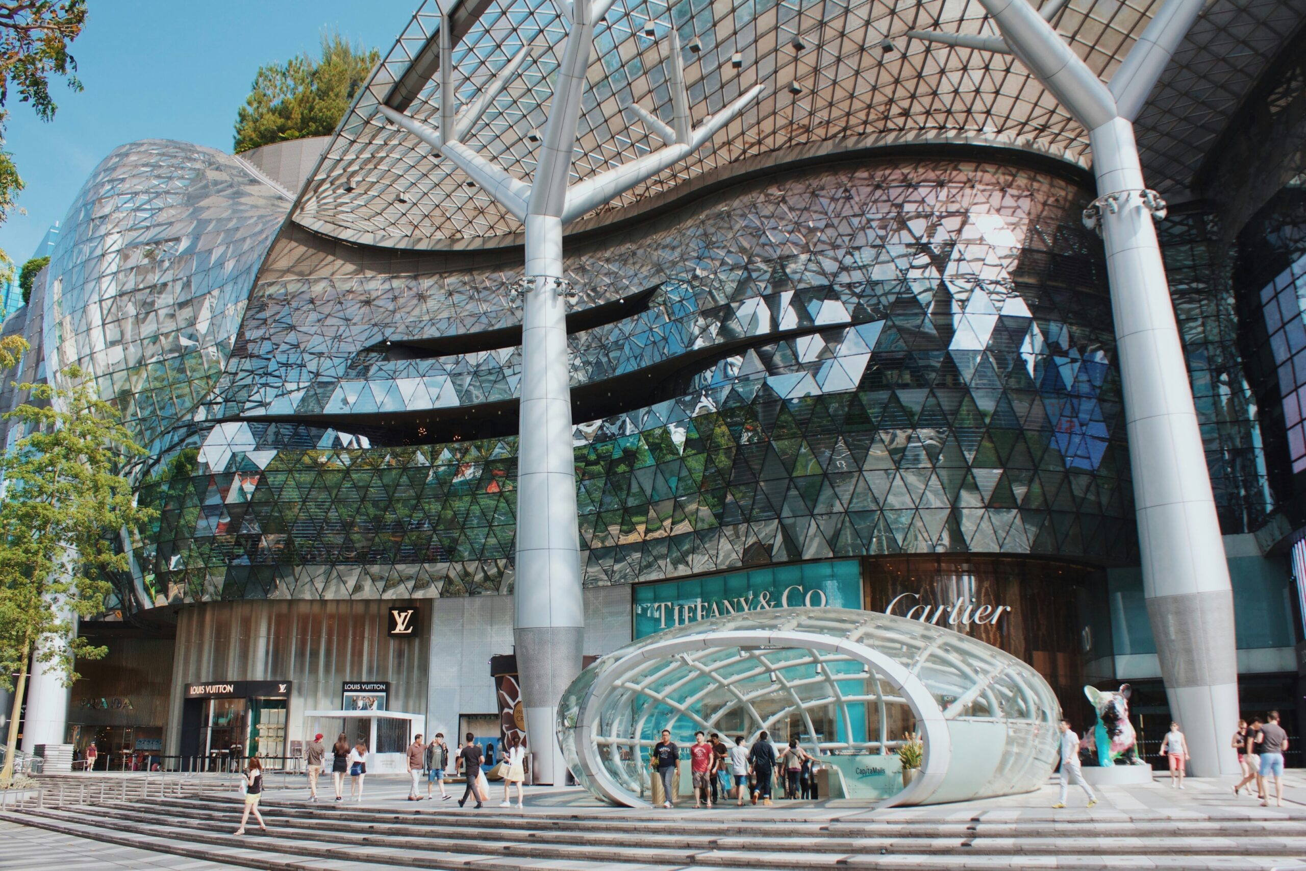 Beyond the Orchard Road : Window displays showcasing high-end fashion brands inside a polished retail corridor.