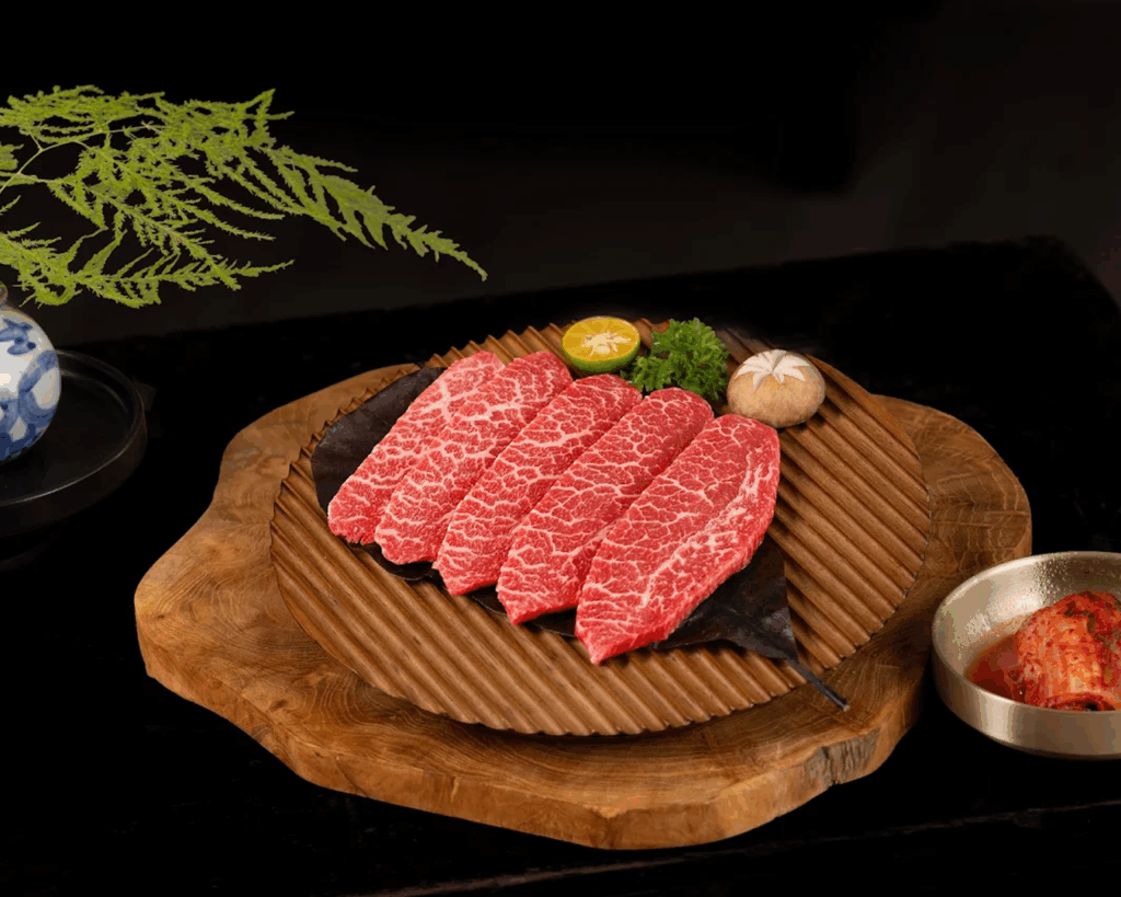 Beyond the Orchard Road : Close-up of premium marble meats ready for the grill, showcasing rich texture and colour.