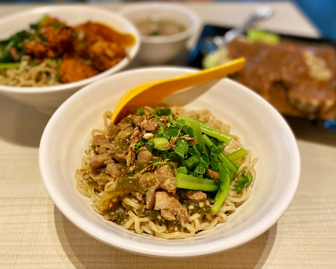Beyond the Orchard Road : A bowl of Indonesian-style chicken noodles at Jtown Café, featuring tender chicken slices, springy noodles and fragrant herbs, beautifully presented to showcase the café’s authentic and homely Indonesian flavours.