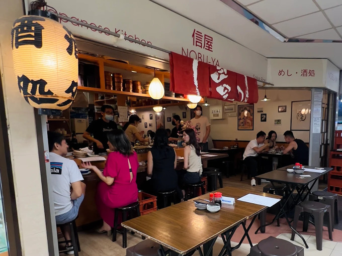 Fortune Centre Food: The moody, minimalist interior of Nobu ya Izakaya, where dim lighting and polished wood evoke the refined calm of a true Japanese sake bar.