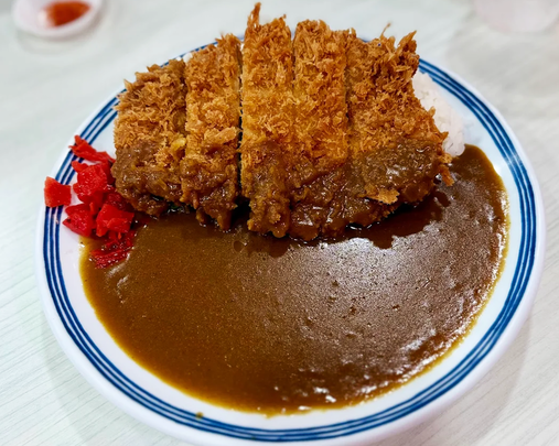 A budget-friendly bowl of Japanese curry and donburi at Maruhachi Donburi & Curry, served with rice and toppings.