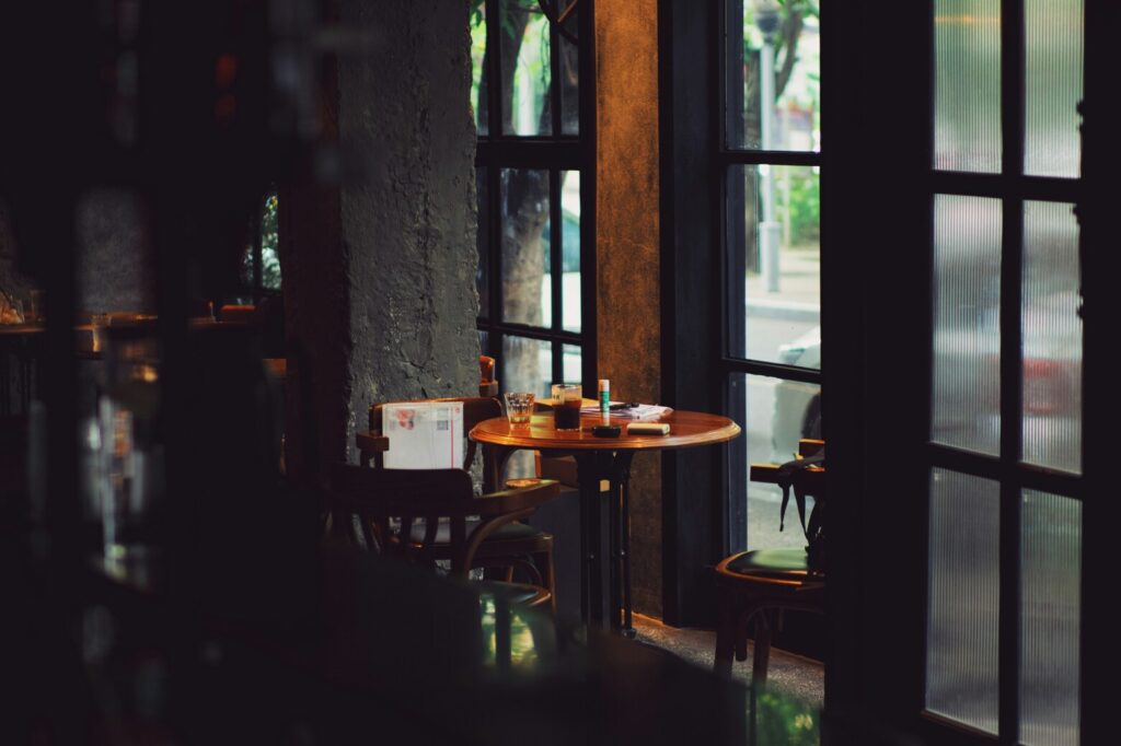 The stylish interior of a Singaporean cafe, with warm lighting, elegant furnishings, and an inviting atmosphere perfect for enjoying coffee and conversation