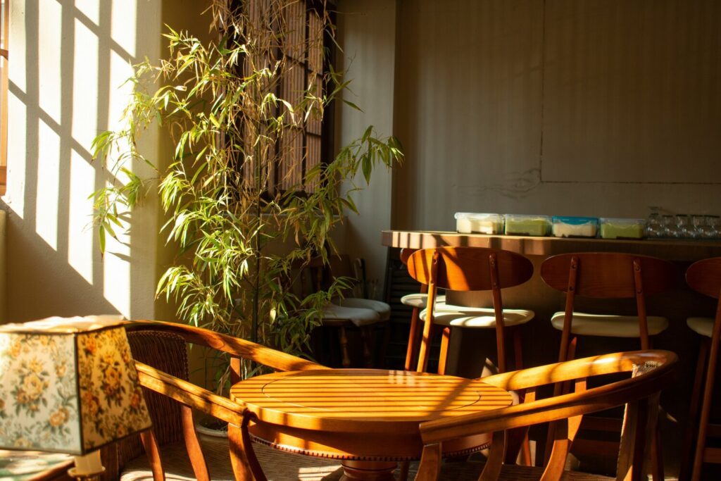 The image depicts an intimate café setting with warm lighting, featuring comfortable seating and a cozy atmosphere perfect for dessert lovers. Guests can enjoy a variety of sweet treats, including cakes and pastries, while sipping on matcha lattes or black coffee in this inviting space.