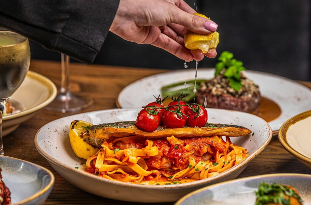 A beautifully plated serving of Renaissance-style Italian pasta, showcasing fresh ingredients and vibrant colours, inviting diners to enjoy an authentic Italian dining experience