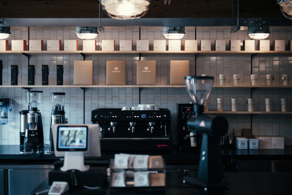 The interior of a premium cafe featuring a sleek, professional coffee machine, ready to craft high-quality coffee beverages in a sophisticated setting