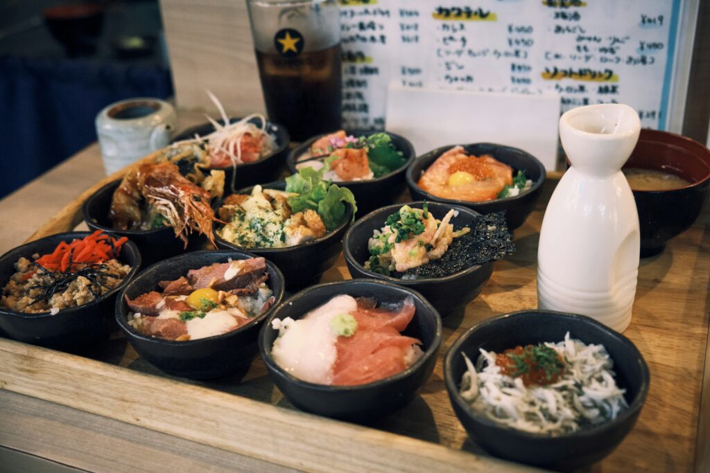 A multi-course Kaiseki meal featuring a selection of seasonal appetisers, simmered dishes, sashimi, and grilled items presented in a beautifully balanced sequence.