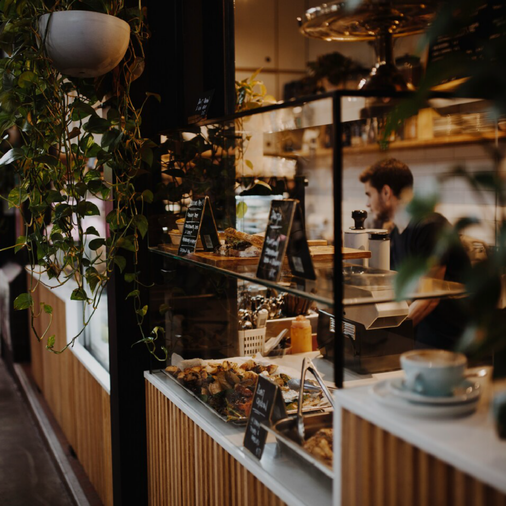 A warm and inviting café interior with thoughtfully arranged seating, soft lighting, and a calm atmosphere designed for relaxed conversations.