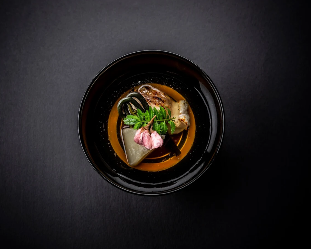 An exquisite Kaiseki dish from Maetomo Japanese Cuisine, highlighting refined techniques and premium ingredients arranged in an elegant modern–Japanese style.