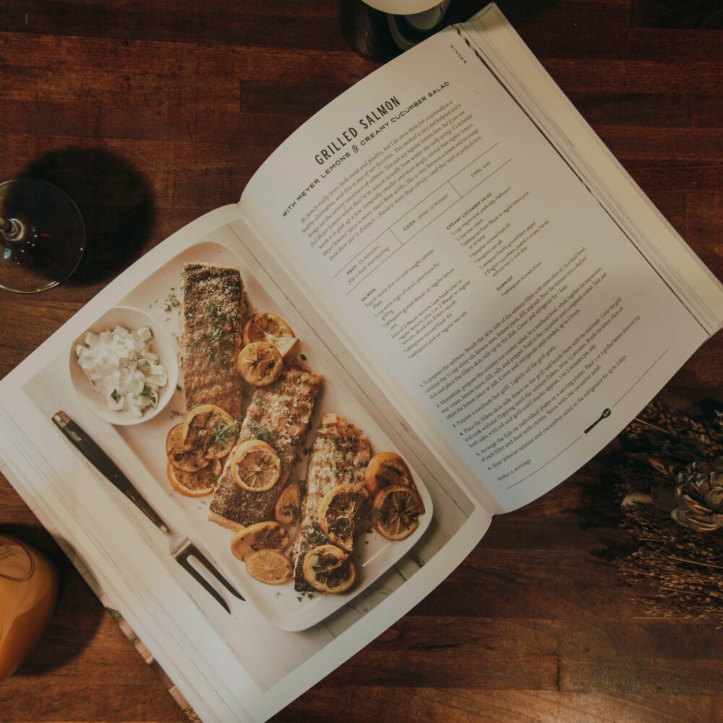 A recipe book resting on a table, open to a page of culinary inspiration, suggesting creativity, learning, and the joy of home cooking.