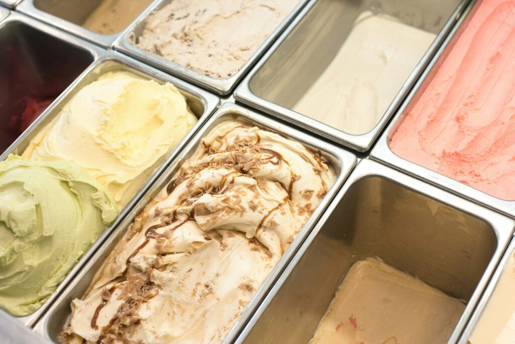 A colourful assortment of gelato flavours displayed in a chilled counter, with smooth, creamy textures and vibrant tones inviting customers to indulge