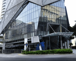 Orchard Central’s modern exterior featuring tall glass panels, vertical greenery, and a sleek urban façade along Orchard Road, Singapore.