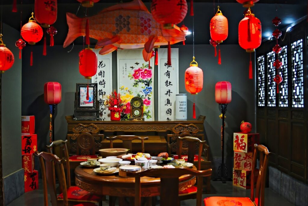 A warmly decorated reunion dinner dining room set for Chinese New Year, with an inviting table arrangement that reflects togetherness and family tradition.