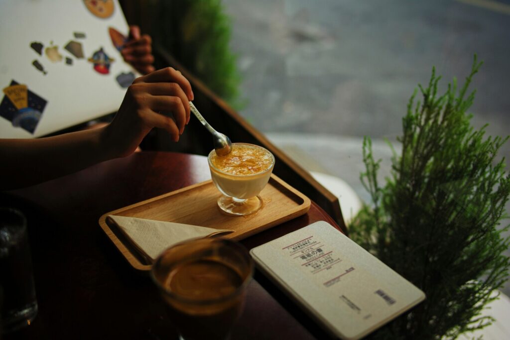 A beautifully plated dessert enjoyed in a dimly lit café, offering a comforting late-night moment for those seeking a sweet escape.