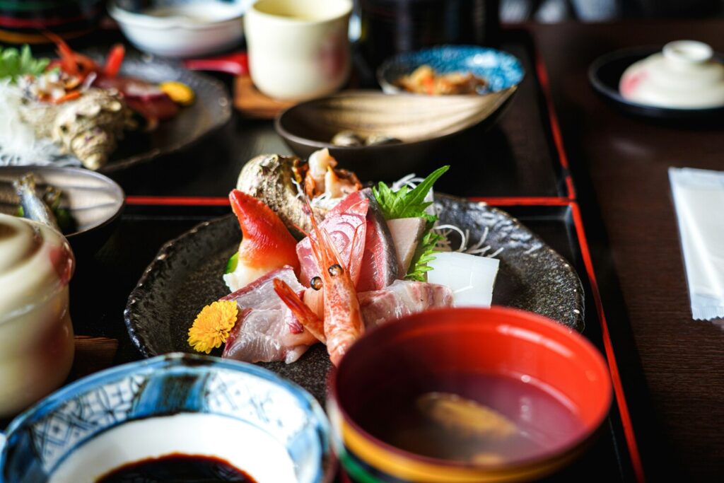 Guests enjoying a traditional kaiseki dining experience, where each course is served with care to highlight balance, seasonality, and Japanese culinary philosophy.