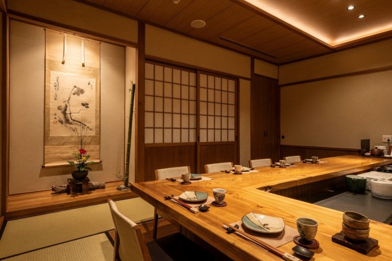 An intimate counter seating arrangement in a sushi restaurant, where guests sit close to the chef, creating a quiet, personal omakase experience.