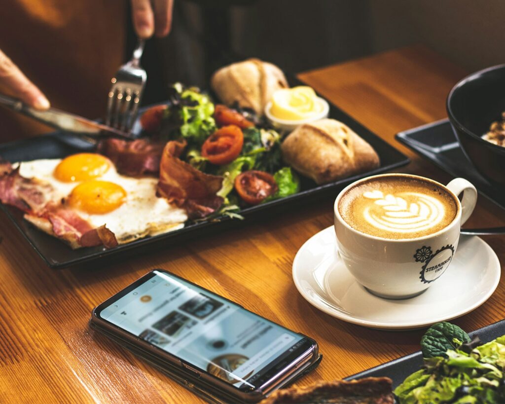 Breakfast set with toast, eggs, and coffee served on a café table, styled for a cosy and relaxed morning dining scene.