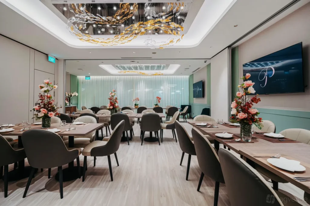 Sophisticated dining room with elegant decor, featuring neatly arranged tables, floral centerpieces, luxurious chairs, and artistic ceiling design.